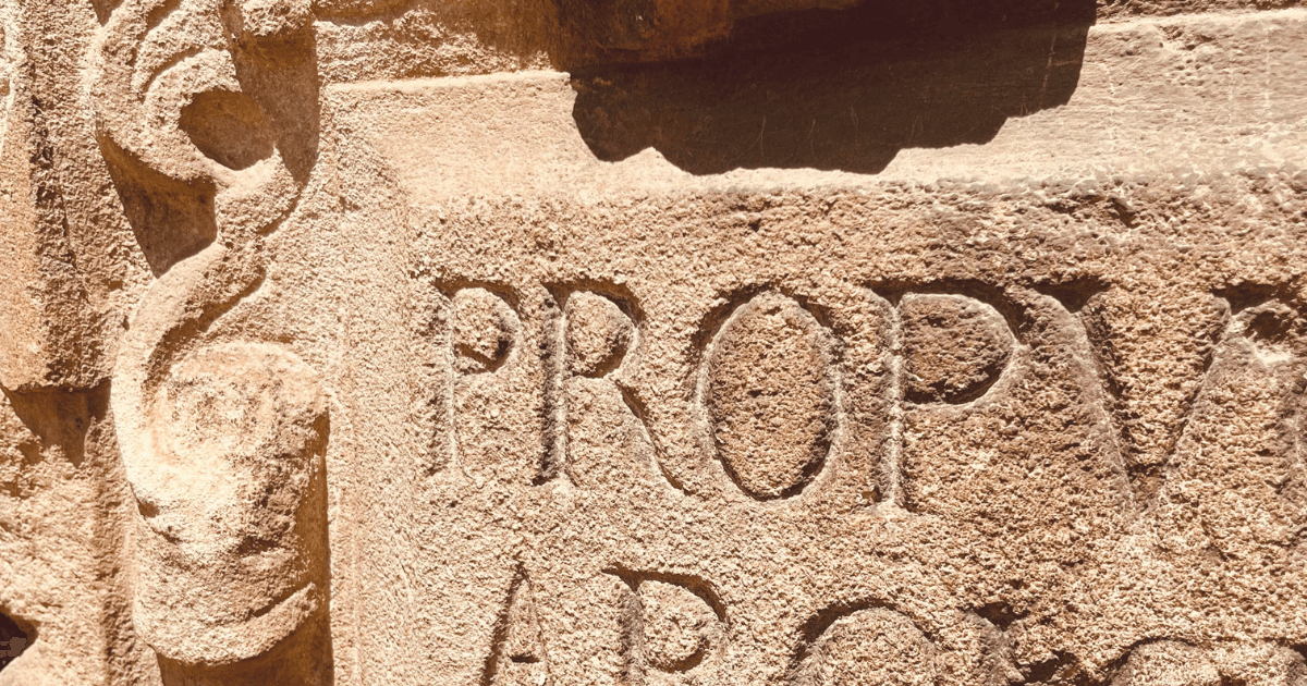 Ornate Latin engravings in the deserted castle courtyard – featured image for the multisensory Ethereal Storytelling mini atmosphere: “Noontide Stillness - An Ethereal Spark” authored by Light By Viktoria.